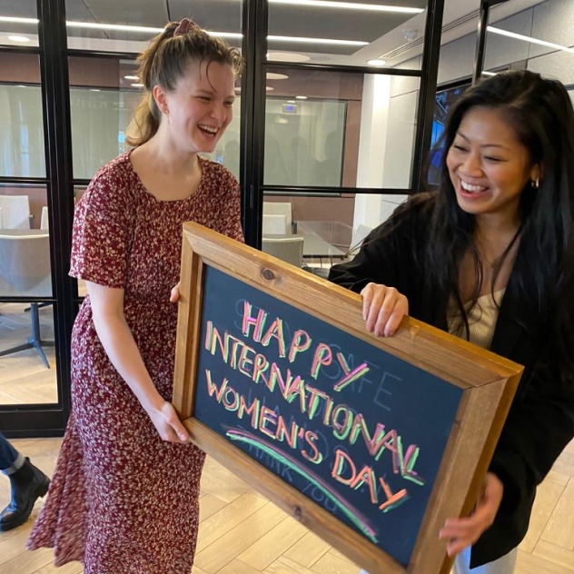 Two Peldon Rose employees with International Women's Day sign