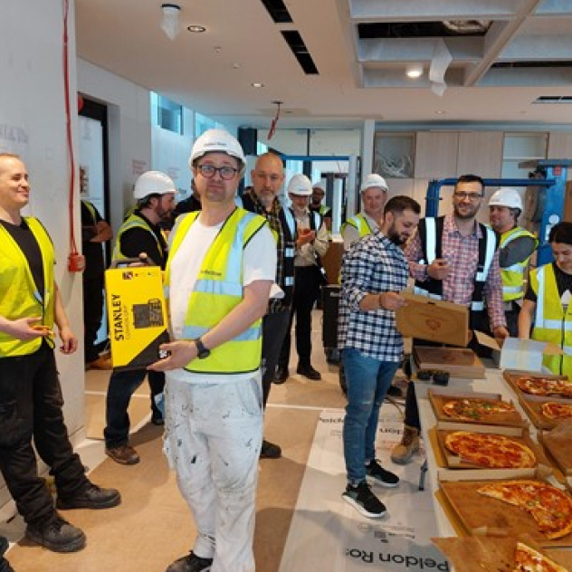 Employees eating pizza