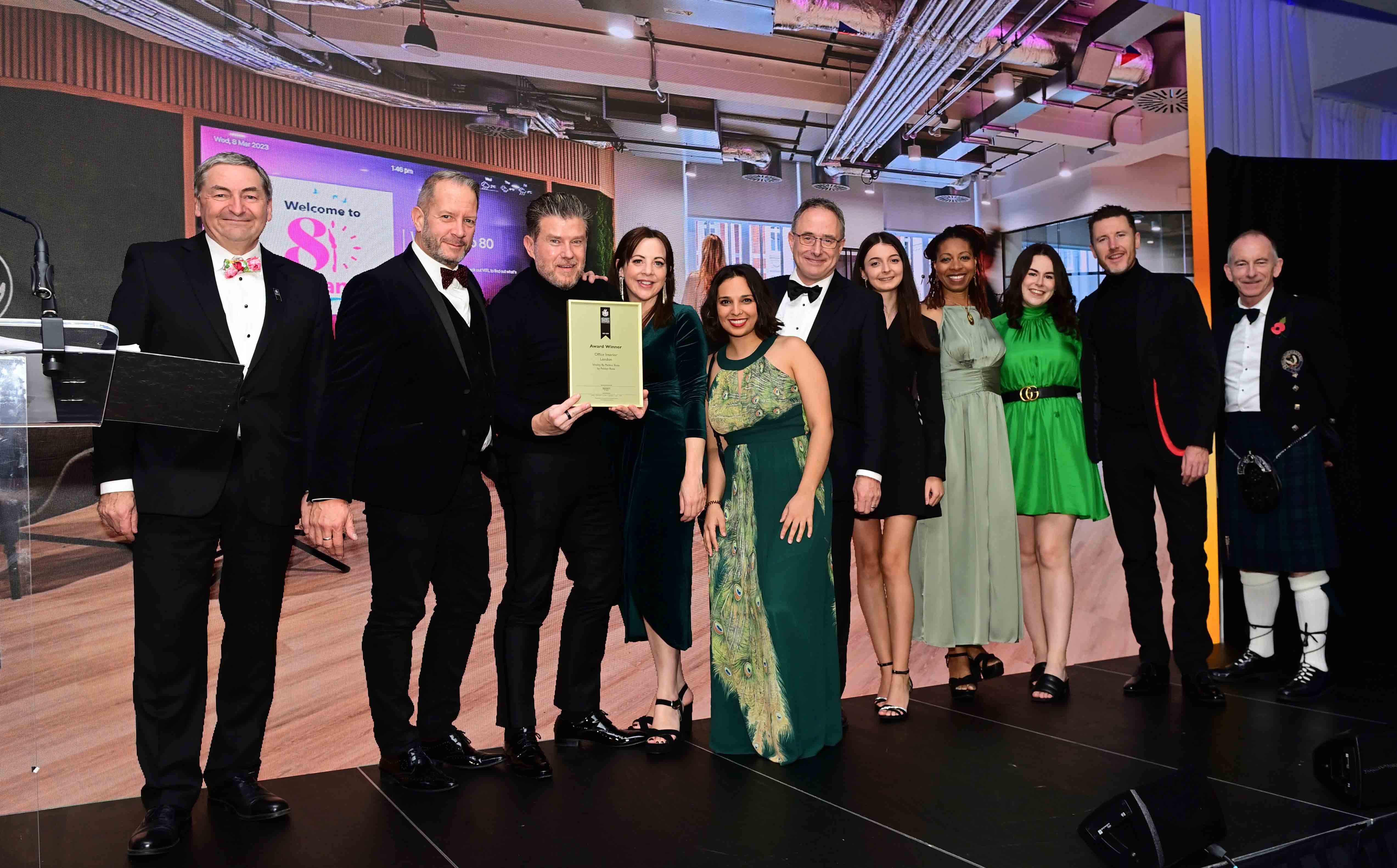 Group of people on stage accepting an award