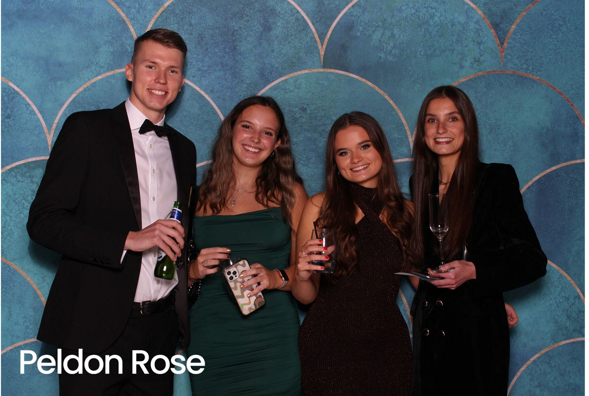 Four people, three women and one man dressed formally