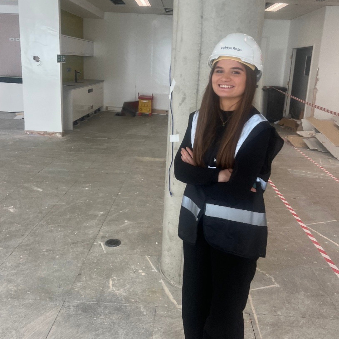 Girl on construction site dressed in hi-vis