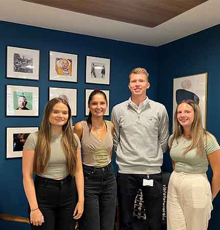 four young people posing for a photo