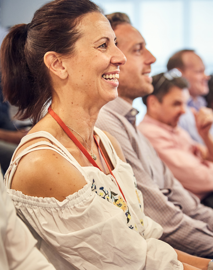 Peldon Rose employee in a meeting looking happy