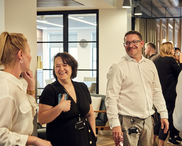 Employees laughing at social event