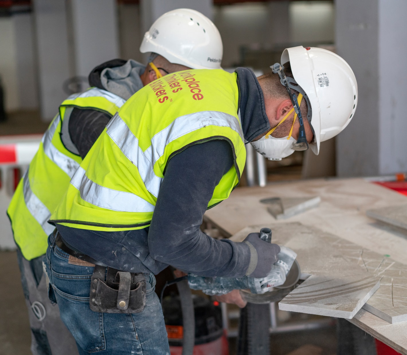 Labourers on a building site cutting materials