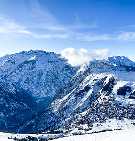 Snow covered mountains with a ski village at the mountain base