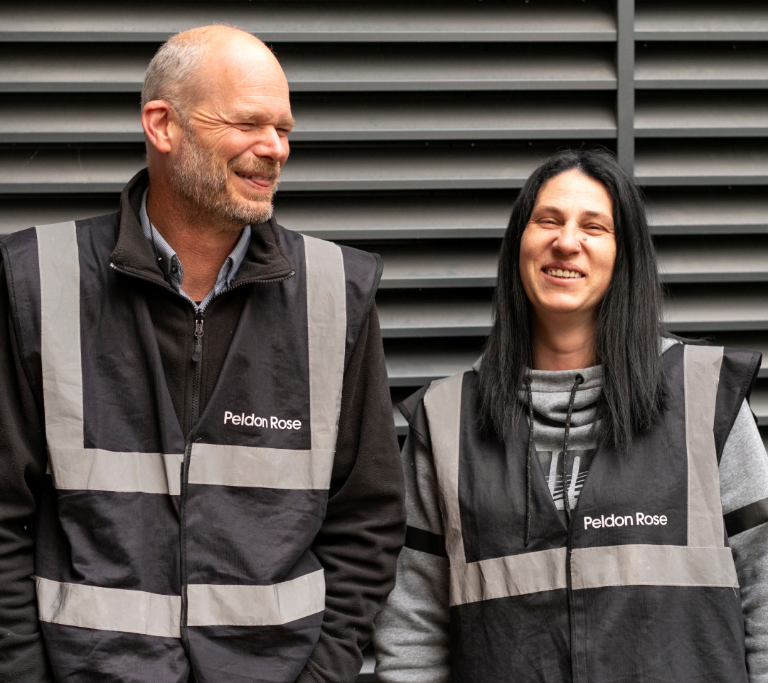 Two Peldon Rose employees in black safety vests