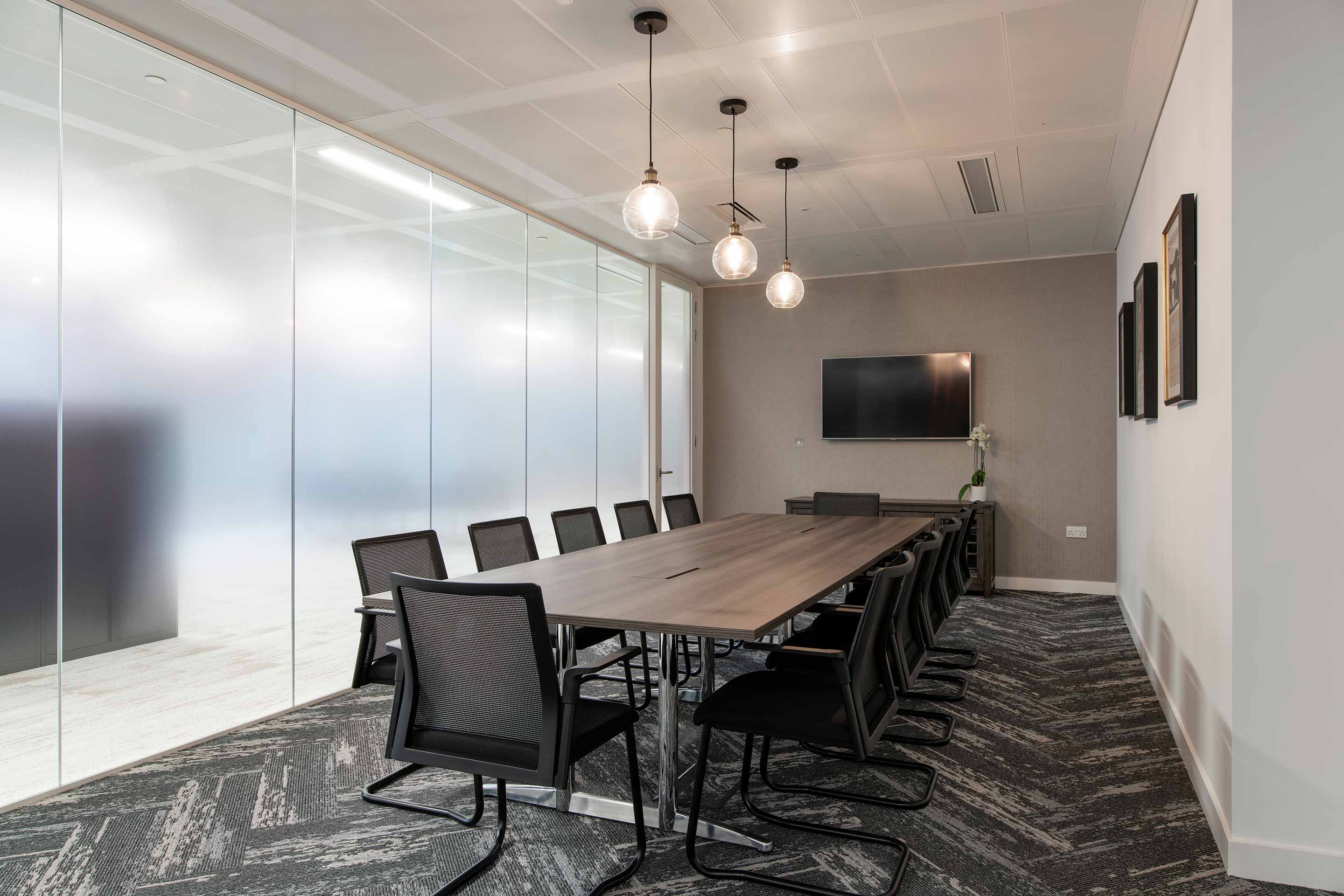 Frosted glass meeting room with large wooden table