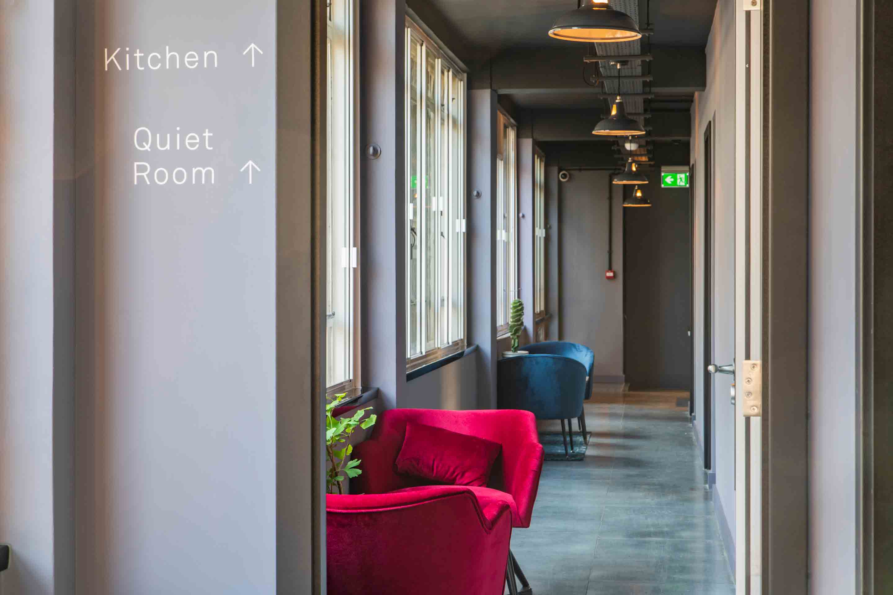 hallway with breakout seating area and plants