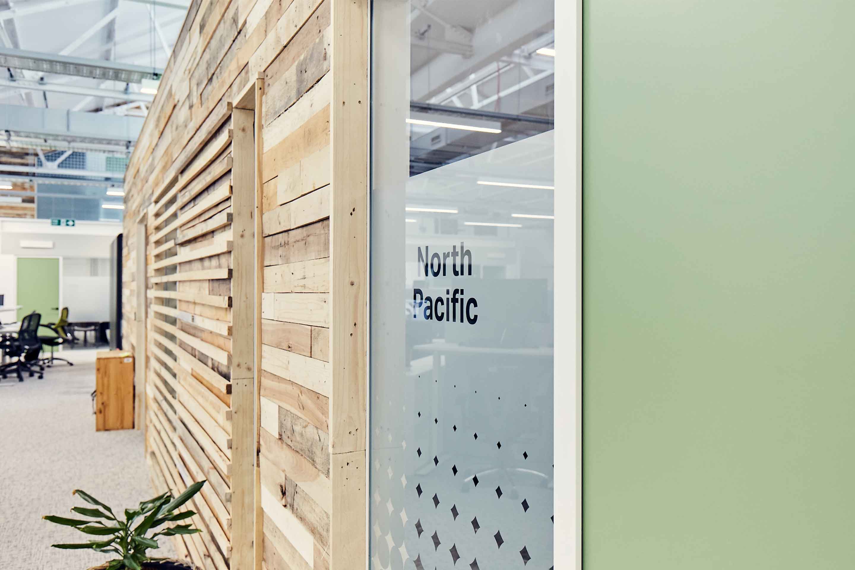 Entrance to meeting room with sage green door and reclaimed wood exterior walls