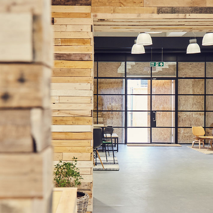 Reception area of a sustainable workspace with reclaimed wood and seating areas