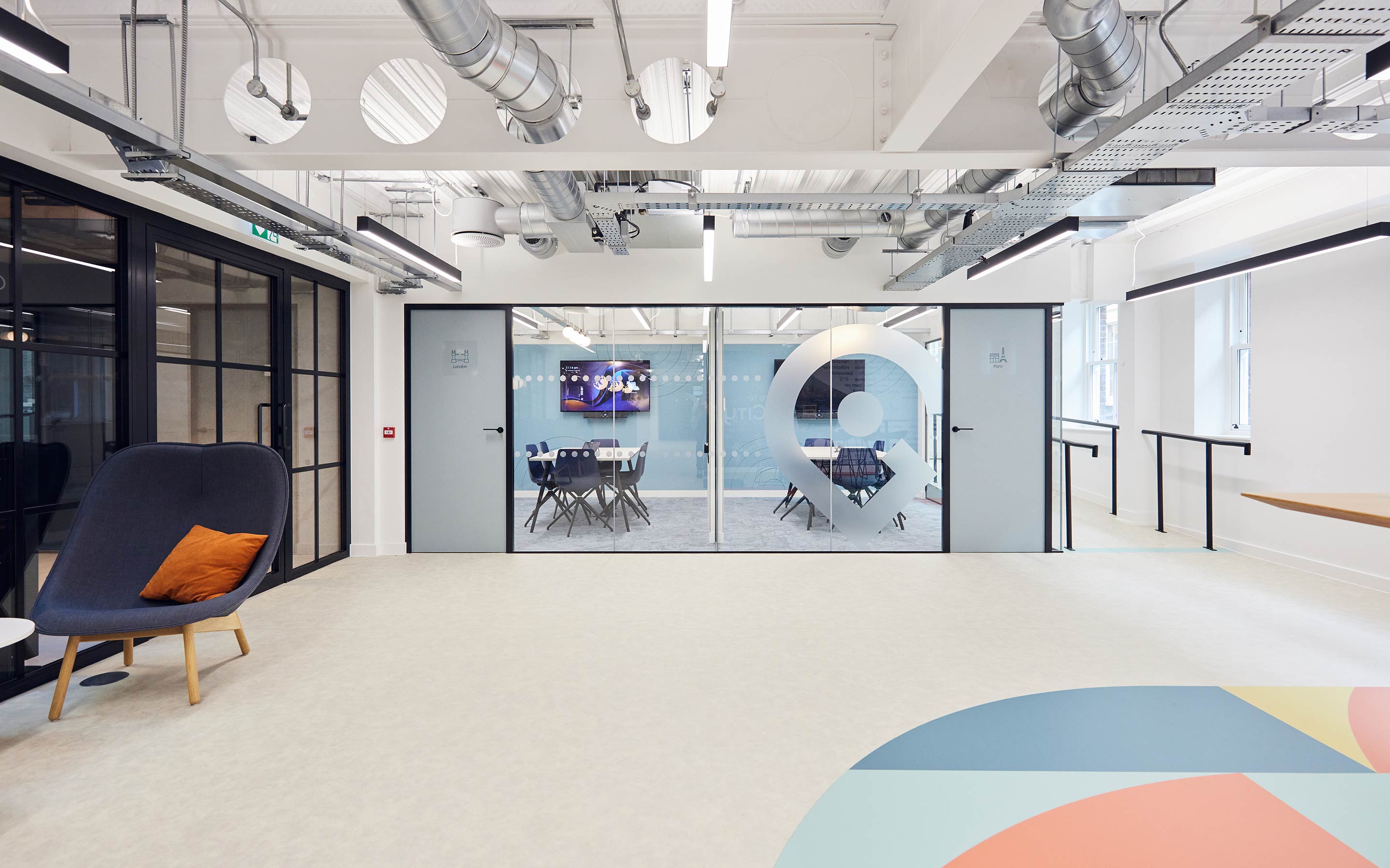 The image shows two meeting rooms with graphic manifestations on the glass