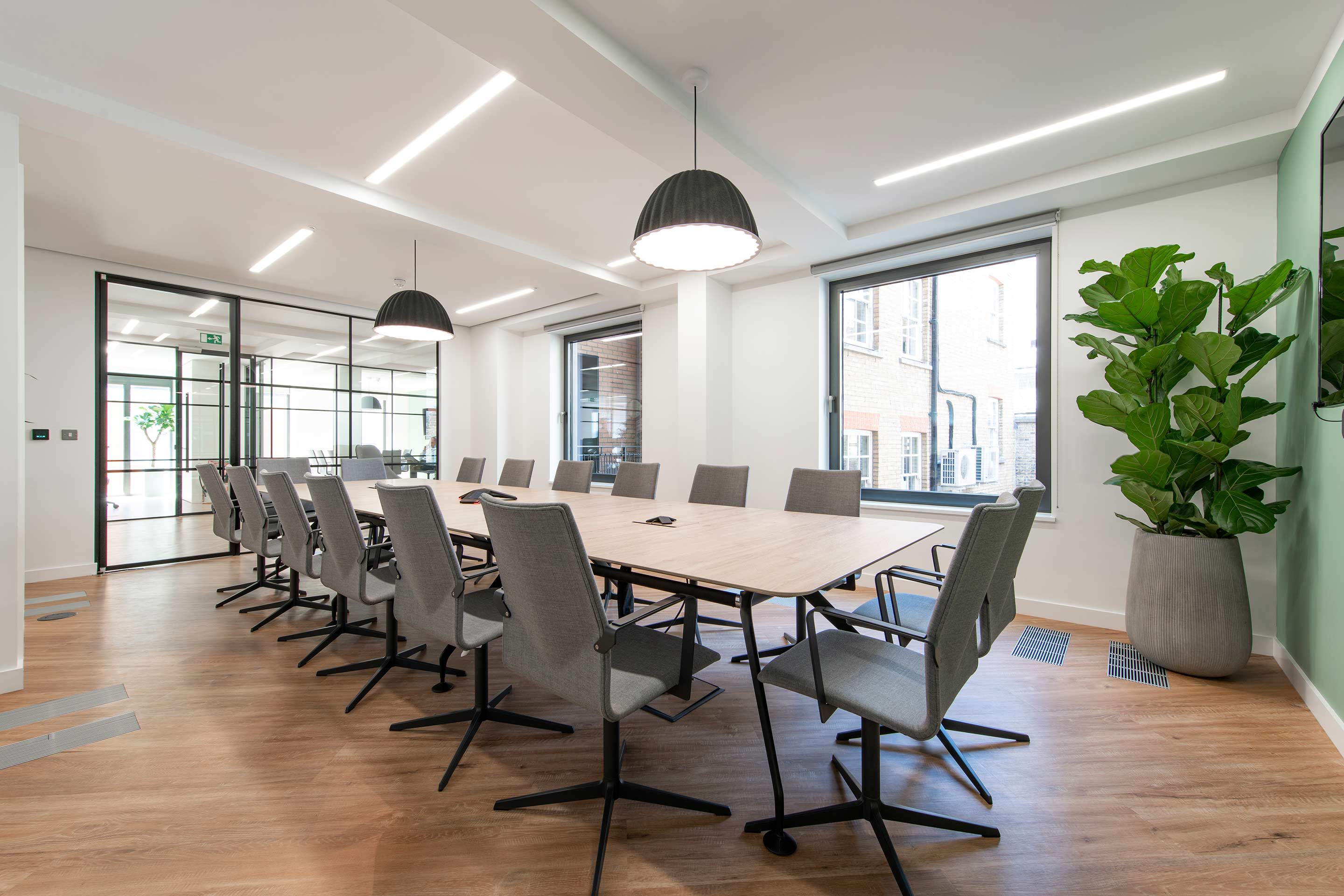 Light boardroom table and biophilic decoration