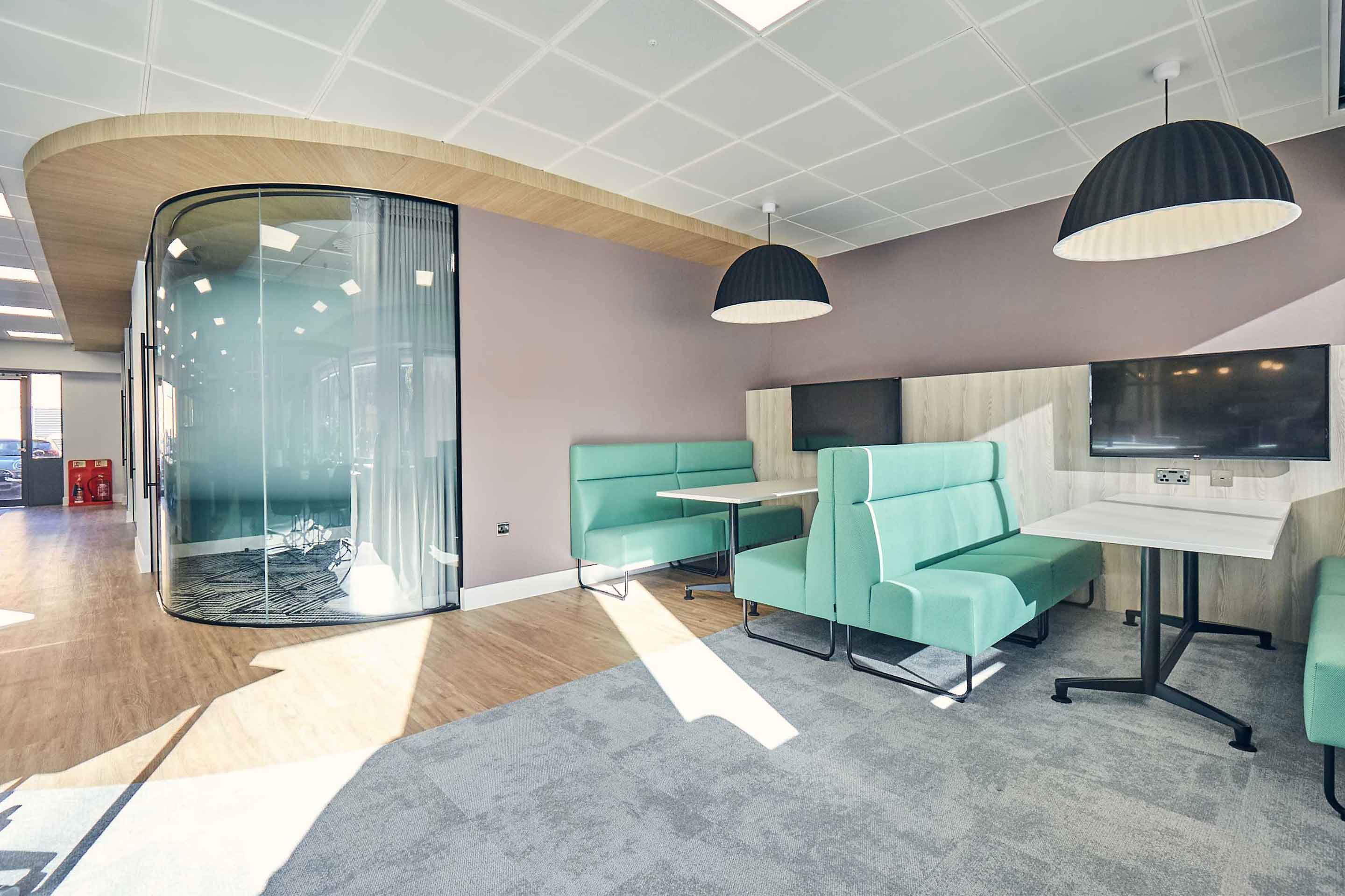 Turquoise booths with AV capabilities for quick meetings and socialising