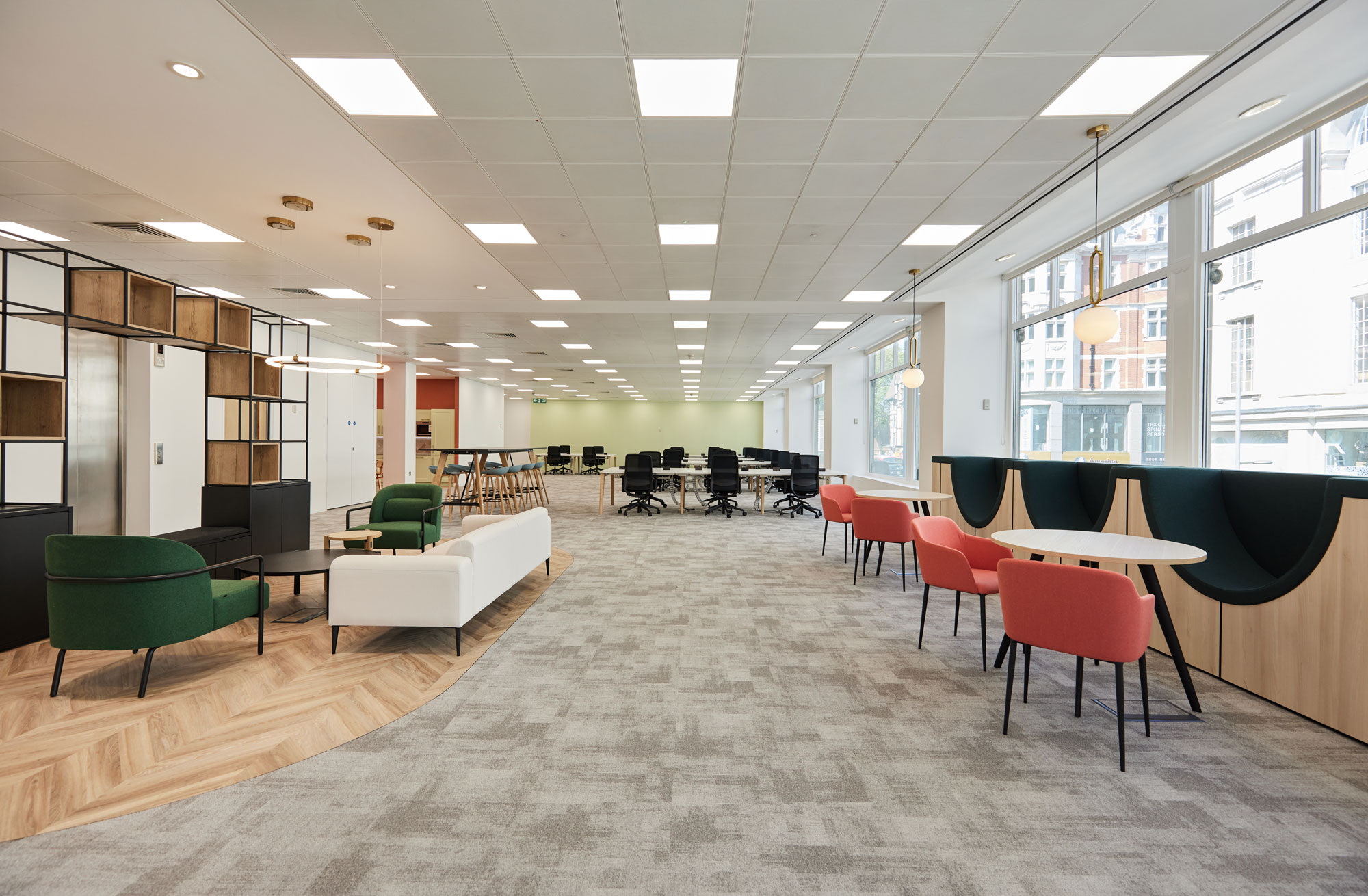A modern, collaborative workspace designed with art deco furniture and feature lighting