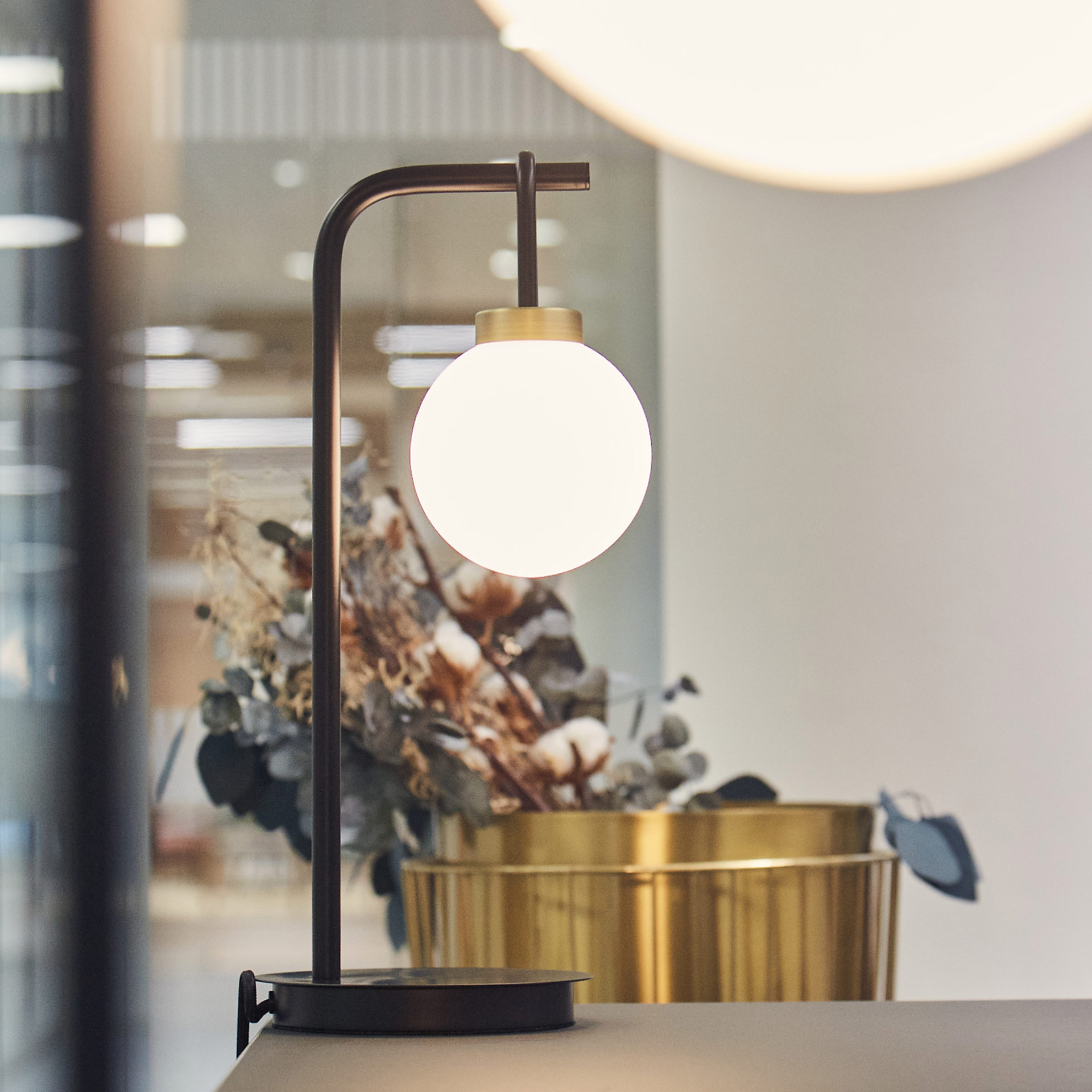 desk lamp in office with flowers in the background