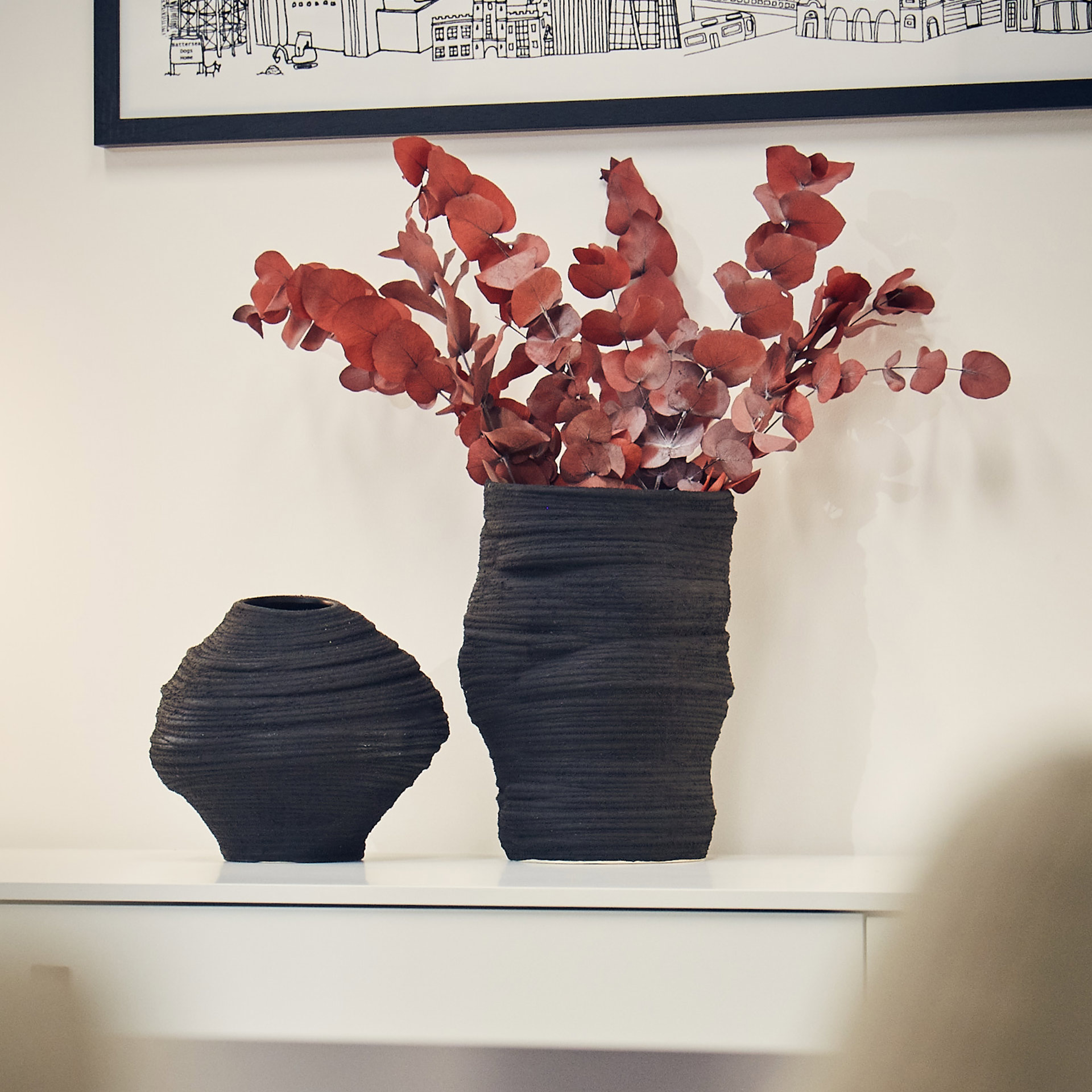 vases with pink biophilia on a cupboard in a meeting room