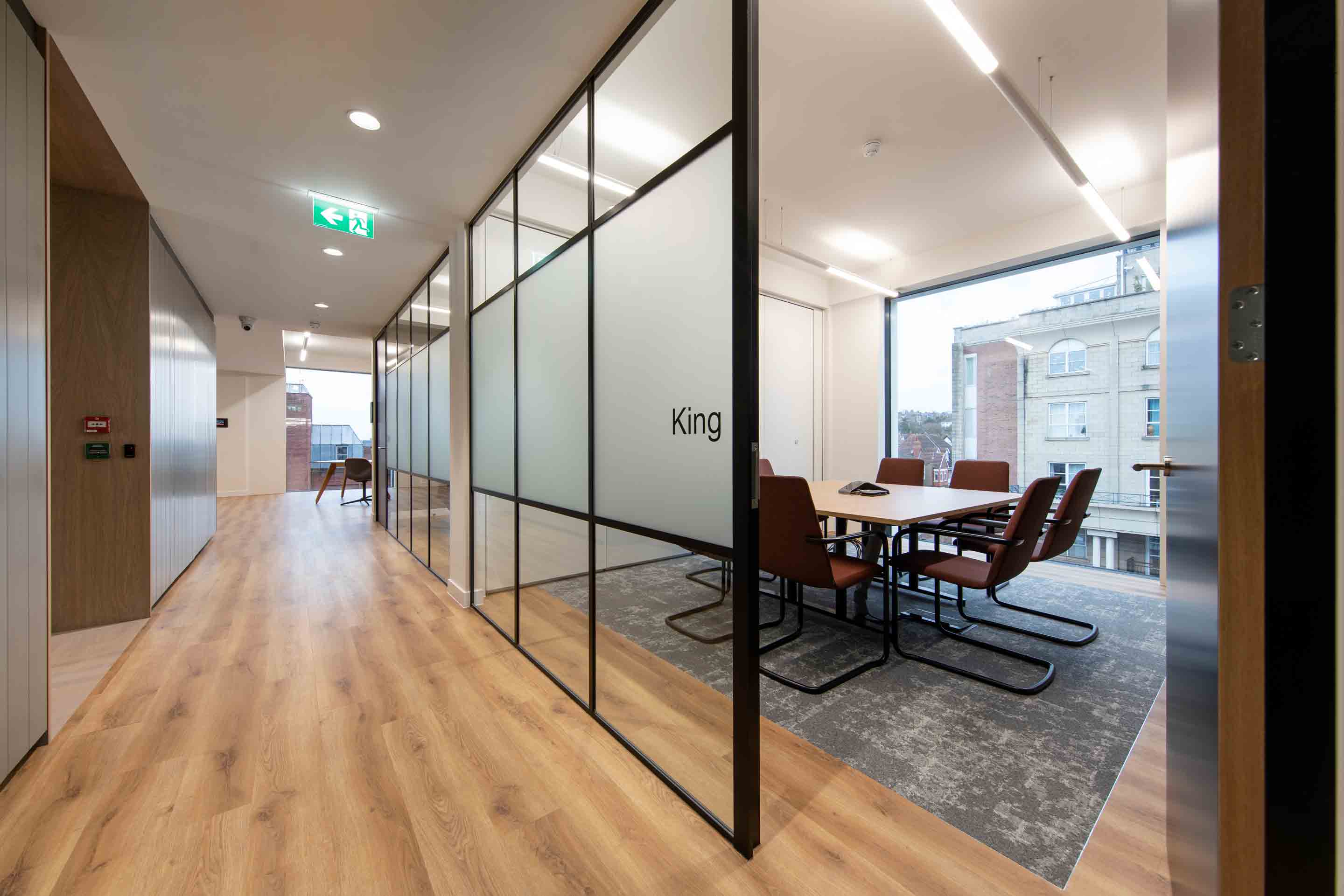 corridor with meeting room space and privacy glass