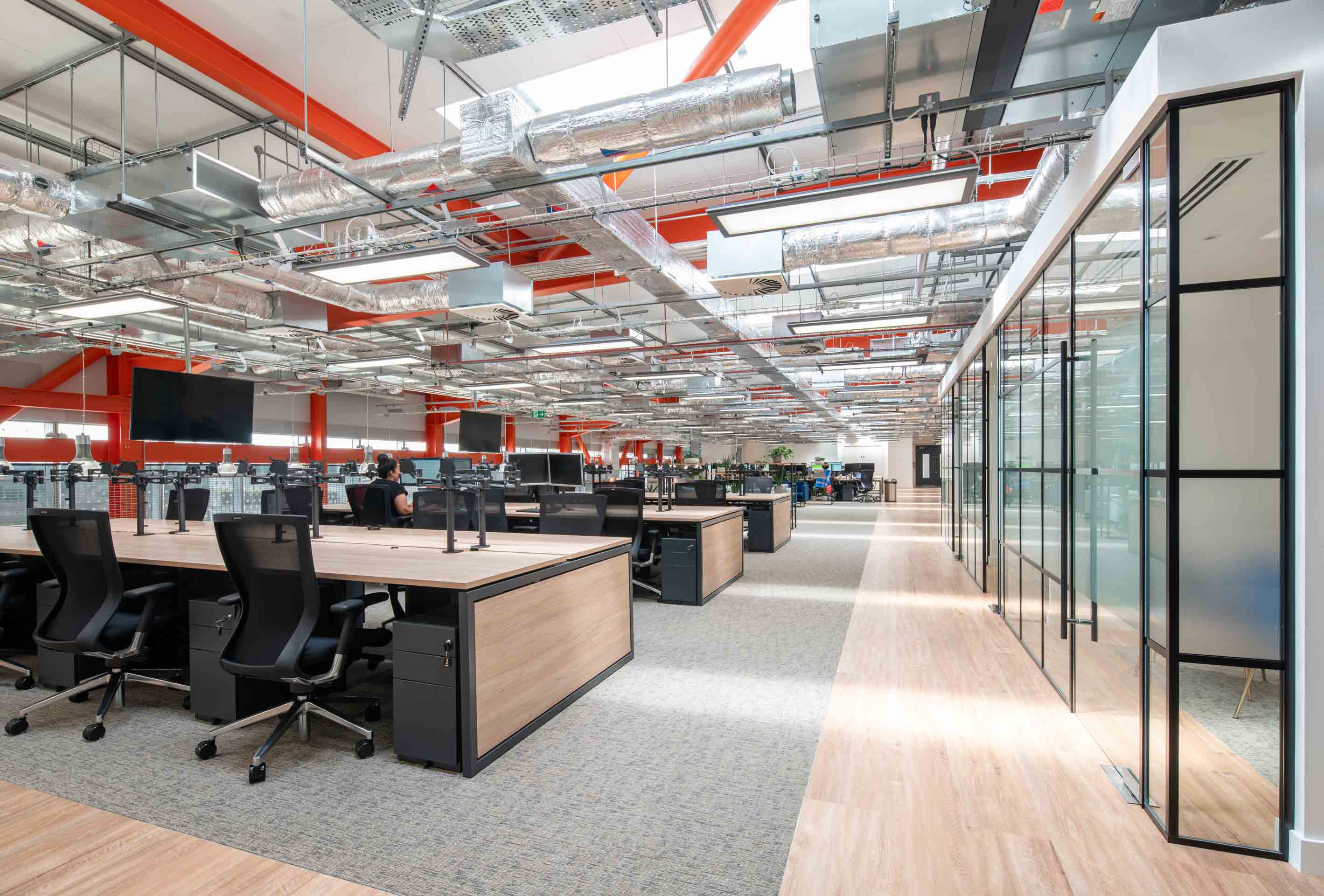 desk space with drawers and computer screens and meeting rooms