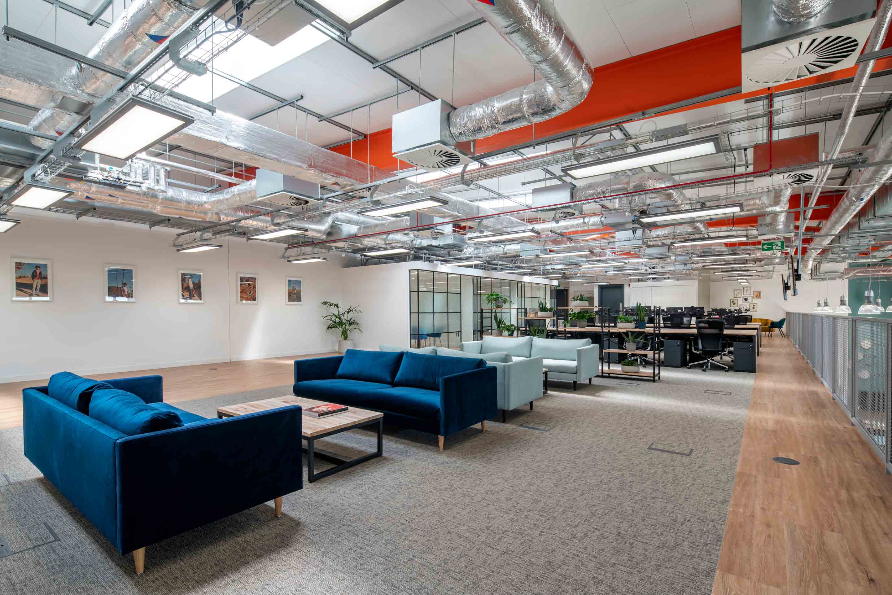 open plan desking and soft seating area with sofas and meeting booths