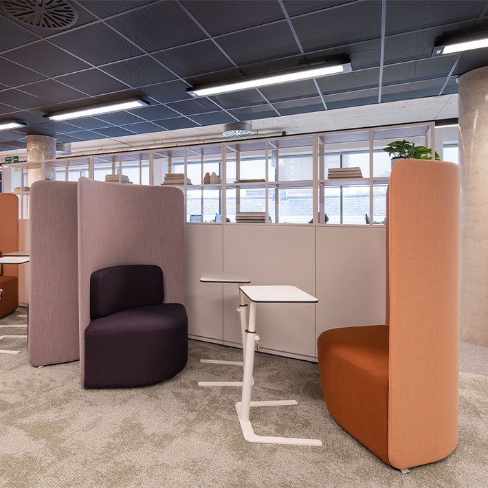 Booth seating area with warm colours and portable laptop table stands
