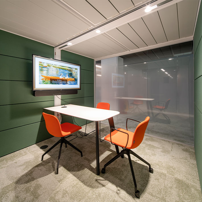 Private meeting room with fogged glass, Zoom screen and forest green acoustic panels