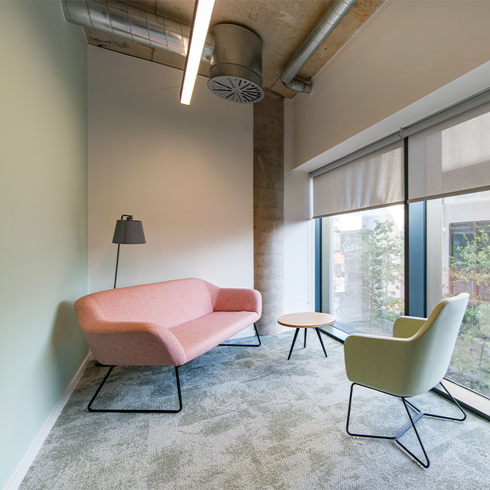 Quiet semi-private office space with soft seating and natural light