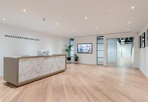 reception desk welcome area with marble finish and plants
