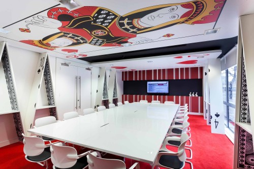 A large meeting room featuring graphics and manifestations of playing cards