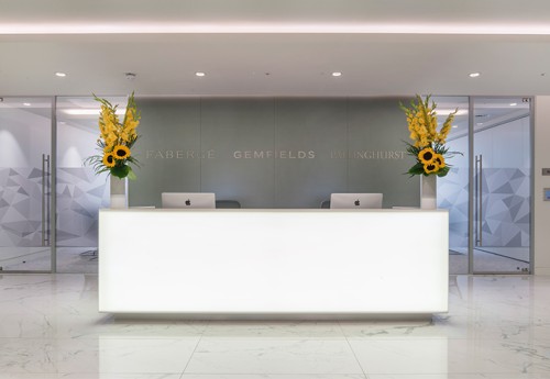 Front desk in white and grey with sunflowers and macs