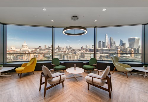 A london city landscape view from a social space with multi-coloured chairs and white tables