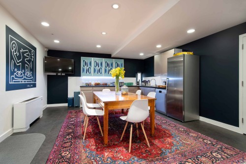 Large wooden table and rug in Wallacespace's kitchen area